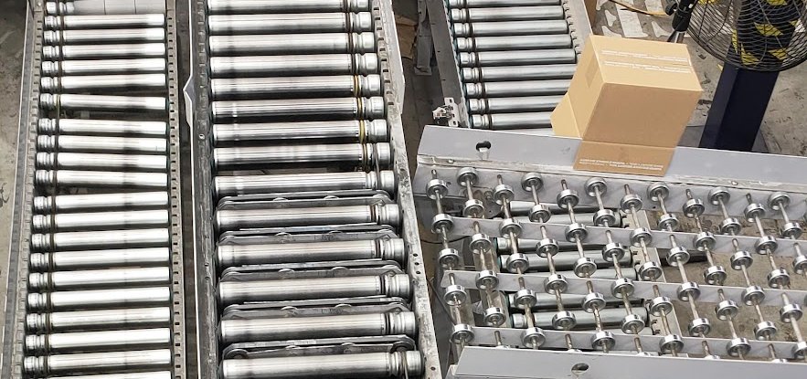 Polished roller conveyors converging in a sortation house