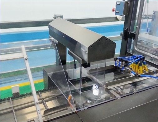 Industrial inspection station — vision hood and sample bed inside a working facility